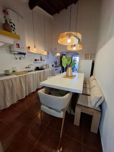 a kitchen with a white table and a counter top at Title e Title - Alentejo in Monforte