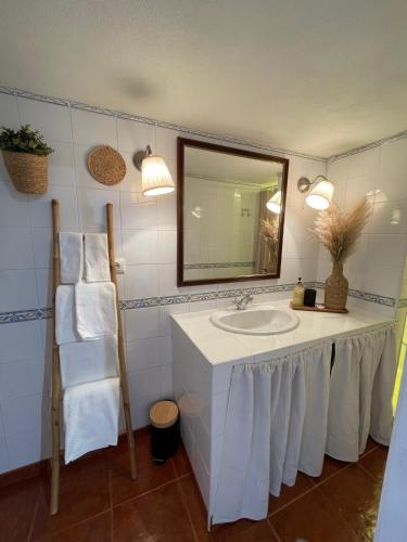 a bathroom with a sink and a mirror at Title e Title - Alentejo in Monforte