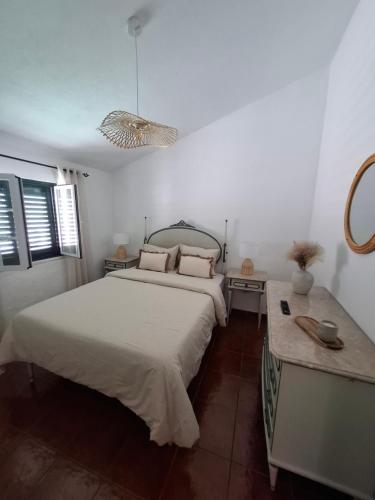 a bedroom with a large bed and a table at Title e Title - Alentejo in Monforte