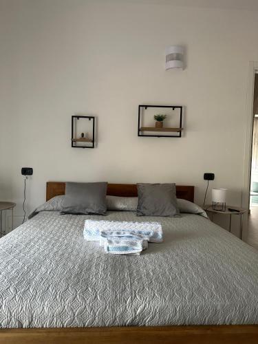 a bedroom with a bed with two pictures on the wall at Guest House Sant'Antonio 