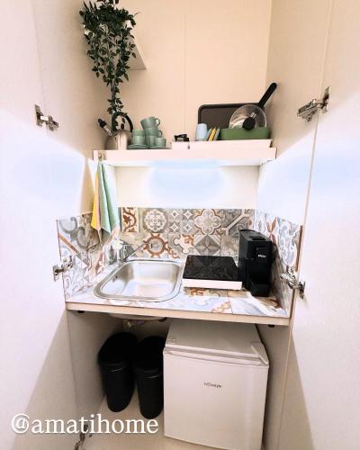 a small kitchen with a sink and a counter at Amati home in Floridia