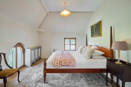 a bedroom with a large bed and a chair at Host & Stay - The Chapel in East Rudham
