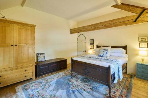 a bedroom with a large bed and a dresser at Host & Stay - The Chapel in East Rudham