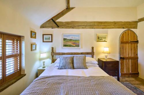 a bedroom with a large bed and a window at Host & Stay - The Chapel in East Rudham
