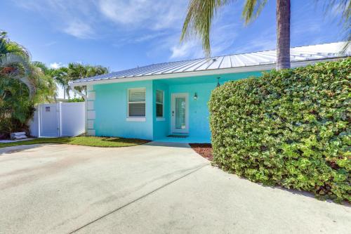 a blue house with a hedge in front of it at Private Pool and Backyard Villa in North Palm Beach in North Palm Beach