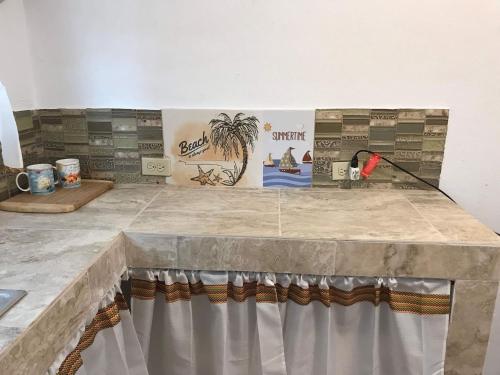 a stone table with a curtain on top of it at Peaceful Beach Studio in the Heart of Puntas in Rincon