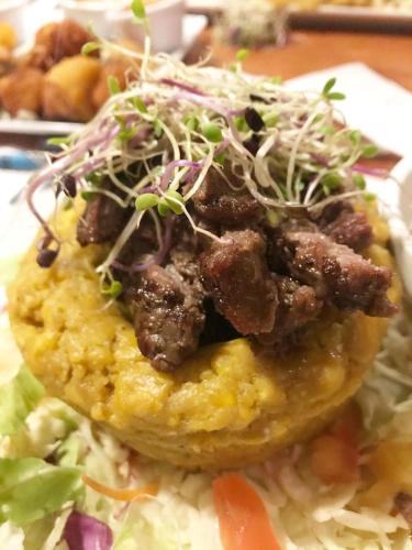 a doughnut with meat and salad on top of rice at Peaceful Beach Studio in the Heart of Puntas in Rincon