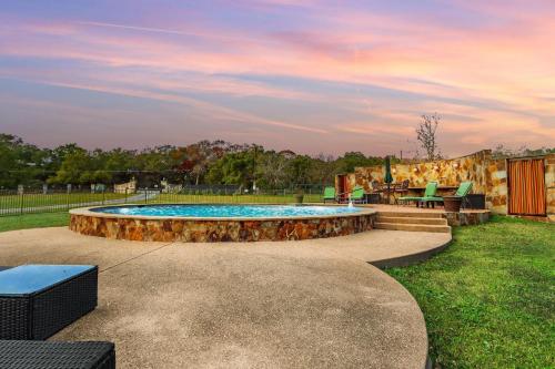 a pool with a table and chairs in a yard at Mill Lodge in Wimberley