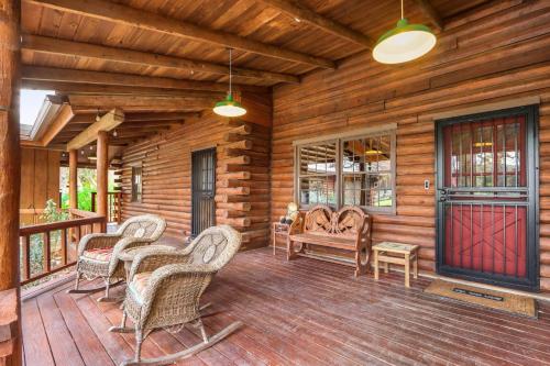 a porch of a log cabin with chairs and a bench at Mill Lodge in Wimberley