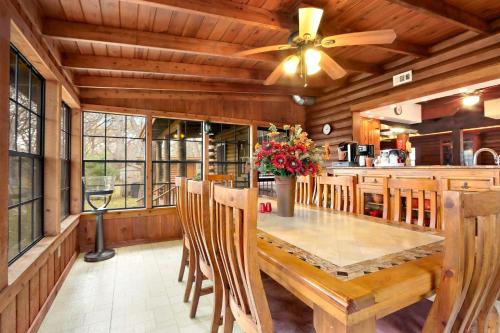 a dining room with a large wooden table and chairs at Mill Lodge in Wimberley