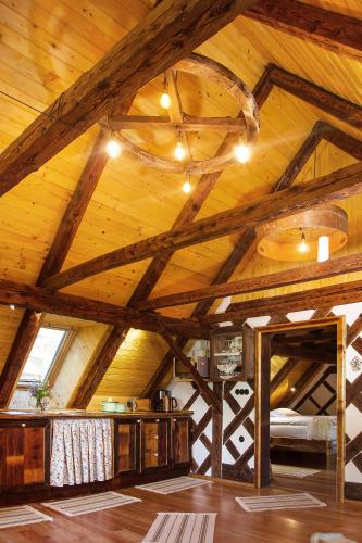 a room with a wooden ceiling with a bed in it at Farm Stay Pirc - Hayloft Apartment in Laško