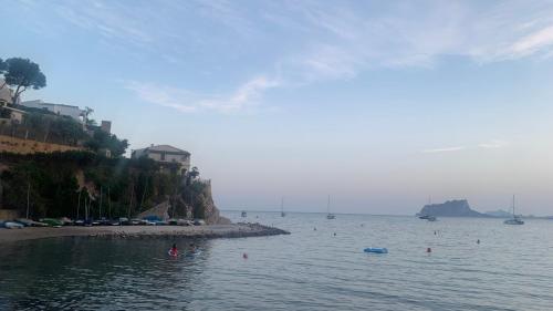 a group of people in the water on a beach at Beachfront Villa in Moraira