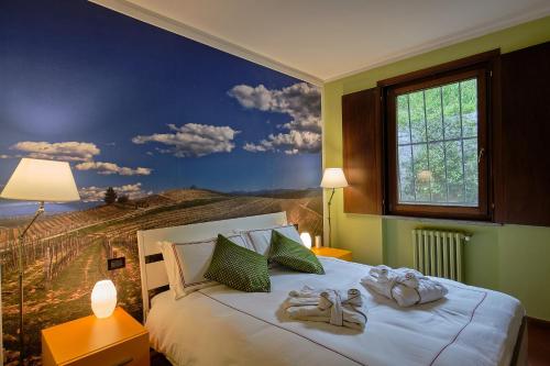 a bedroom with a large bed with shoes on it at Giarvino Boutique Guest House in Acqui Terme