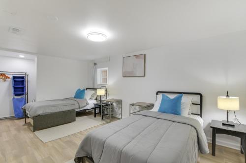 a bedroom with two beds with blue pillows at Logan Square Urban Oasis: 2 Mi to Local Hotspots! in Chicago