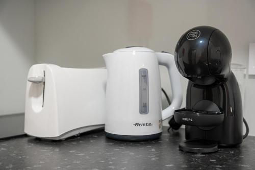 a toaster and a coffee maker on a counter at GuestReady - Practical city hideout in Gaia (C) in Vila Nova de Gaia
