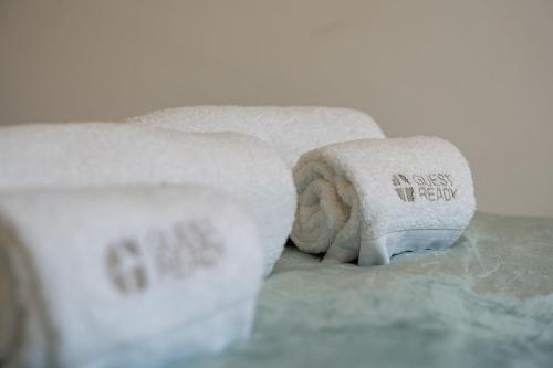 a towel with writing on it sitting on a bed at GuestReady - Practical city hideout in Gaia (C) in Vila Nova de Gaia