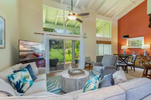 a living room with a couch and a table at Puamana 19C condo in Princeville