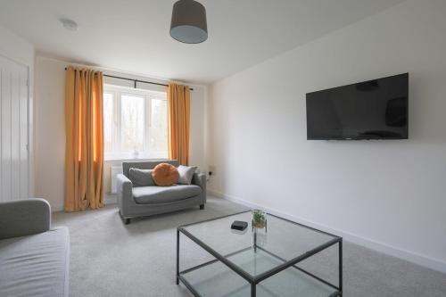 a living room with a couch and a table at The Haven – Modern 4-Bed Home with Garden in Cardiff