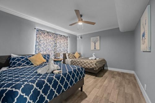a bedroom with a blue and white bed and a couch at Stylish 2BR Saltwater Pool in Houston