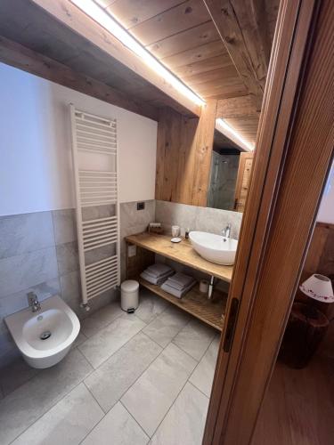 a bathroom with a sink and a toilet at BeB LUCA76 in Avise
