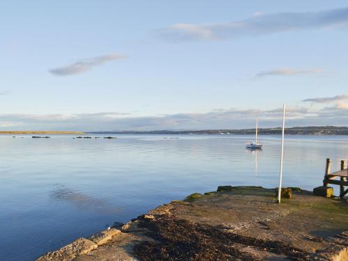a view of a body of water with a sail boat at Old Inzievar in Blairhall