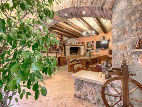 a large living room with a stone wall and a table at Apartment Lorena by Interhome in Buje
