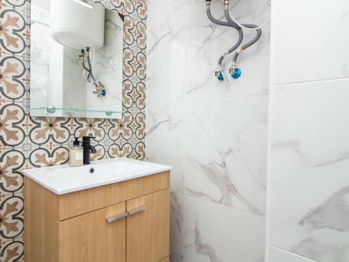 a bathroom with a sink and a mirror at Neptuno Sea View Apartment - Sea View & Pool & Top Location in Albufeira