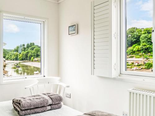 a white chair in a room with a window at Holiday Home Cobble Cottage by Interhome in Lerryn
