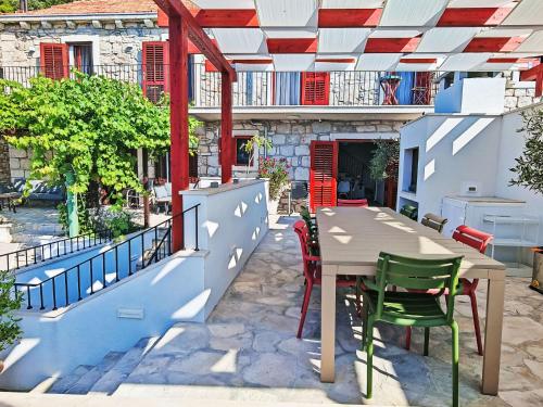 a patio with a table and chairs on a balcony at Holiday Home Prusina by Interhome in Smokvica