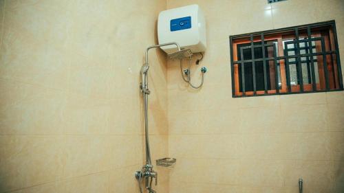 a shower in a bathroom with a window at NJIRO 4BDR FAMILY HOME NEAR RESTURANTs AFCON EXERCISE Field in Arusha