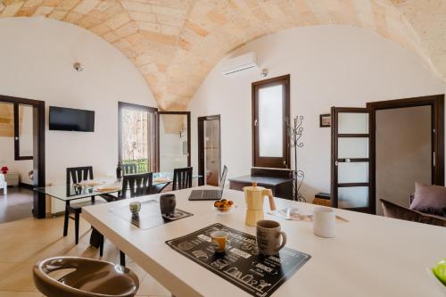 a living room with a table and chairs at La Dimora di Chiara - Salento Selection in Monteroni di Lecce