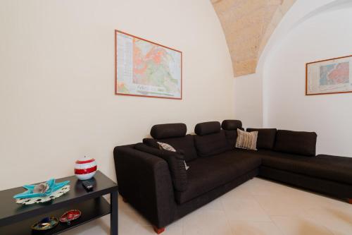 a living room with a couch and a table at La Dimora di Chiara - Salento Selection in Monteroni di Lecce