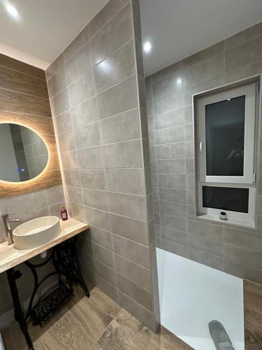 a bathroom with a sink and a mirror at COLMAR and C0 in Ingersheim