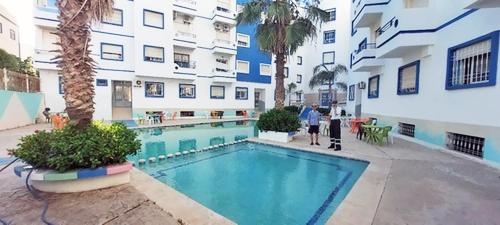 a swimming pool in the middle of a building at Charming apartment in marvelous Martil with swimming pool in Martil