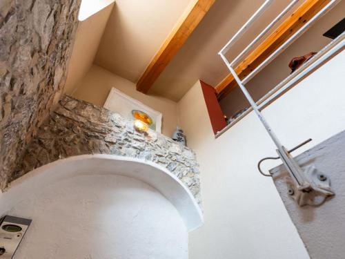 a staircase in a house with a stone wall at Apartment A Dutch Place by Interhome in Airole