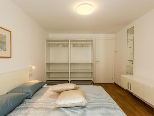 a bedroom with two beds and a closet at Apartment Persico by Interhome in Consiglio di Rumo