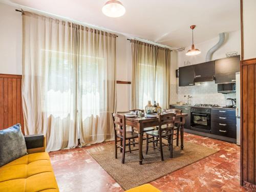 a kitchen and dining room with a table and chairs at Apartment Celeste by Interhome in Cinquale