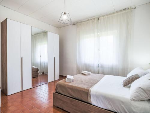 a bedroom with a large bed and a mirror at Apartment Celeste by Interhome in Cinquale