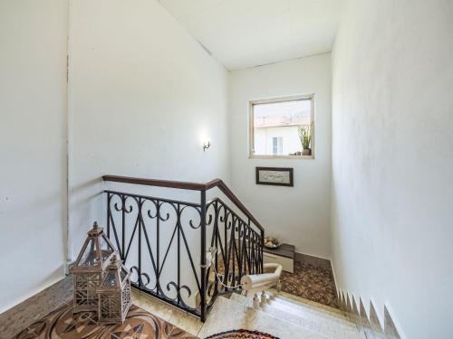 a staircase in a white room with a window at Apartment Celeste by Interhome in Cinquale