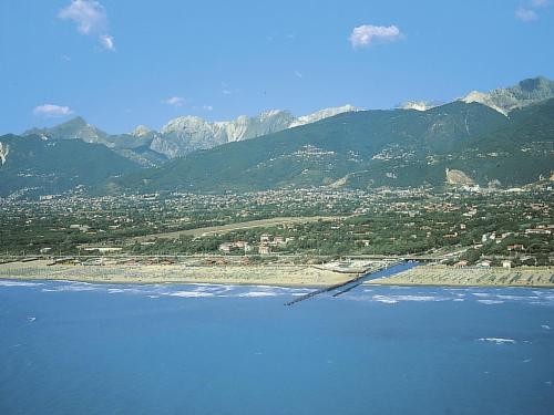 a view of a beach with mountains in the background at Apartment Celeste by Interhome in Cinquale