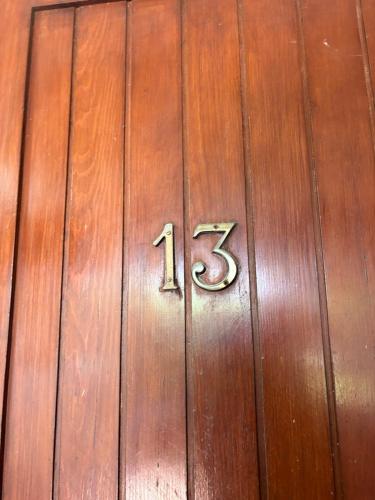 a wooden door with the number on it at Casa Aaron - Monolocale con veranda sul mare in Stintino