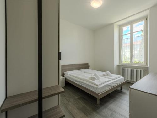 a white room with a bed and a window at Apartment Leoni by Interhome in Rovereto