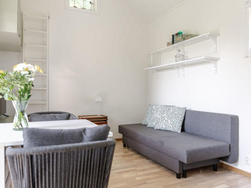 a living room with a couch and a table at Holiday Home Särdals Lycke by Interhome in Steninge