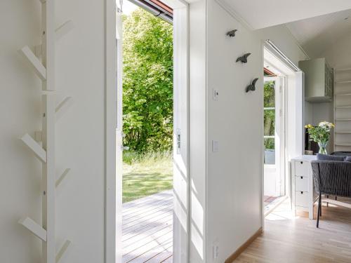 a hallway with a door leading to a yard at Holiday Home Särdals Lycke by Interhome in Steninge