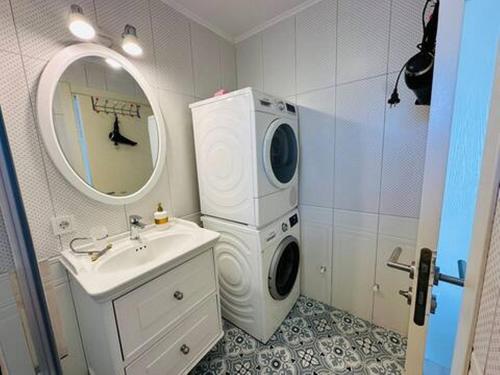 a bathroom with a washing machine and a sink at Evalacati - Villa Harnup- Tamamen Müstakil Villa in Alacati