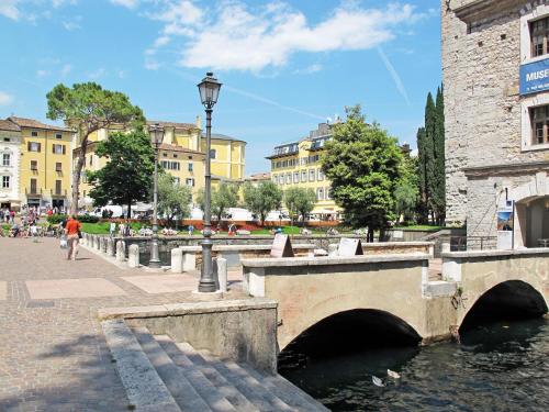a bridge over a river in a city with buildings at Apartment Boschetto by Interhome in Riva del Garda