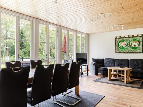 a living room with black chairs and a table at Holiday Home Jönsamåla by Interhome in Ryd