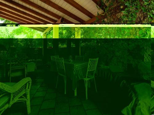 a patio with chairs and a table and a roof at Villa Villa Al Mare by Interhome in Su Forti