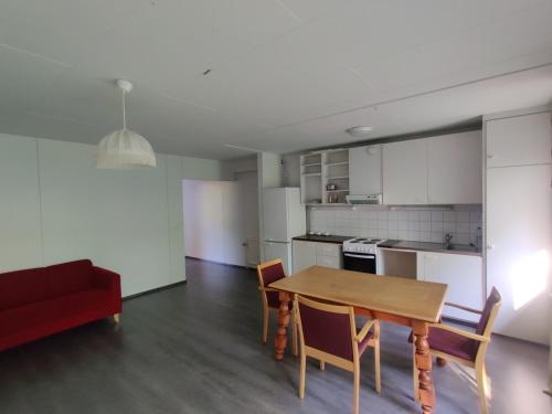 a kitchen and dining room with a table and chairs at Simbi Rooms & Apartments in Savonlinna