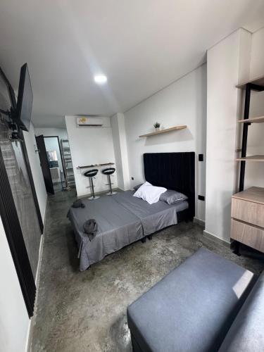 a bedroom with a bed and two tables in it at APARTAHOTEL DdKk in Cali